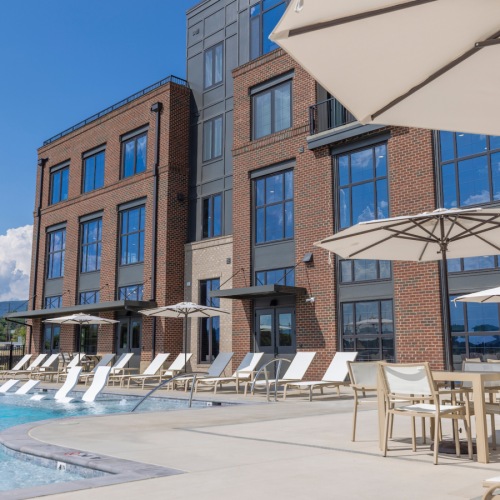 Resort-style infinity swimming pool with panoramic mountain views.