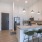 Open concept floor plans with eat-in kitchens and pendant lighting.