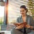 a person sitting on a couch reading a book