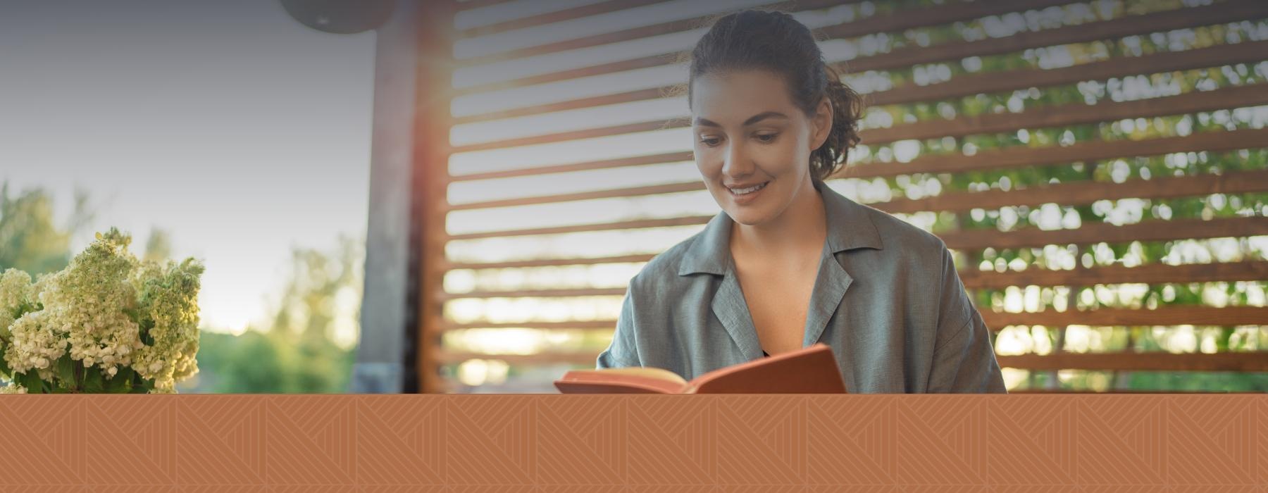 a person smiling reading a book